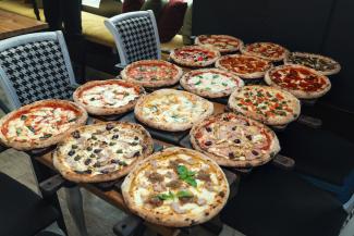 Table full of pizzas